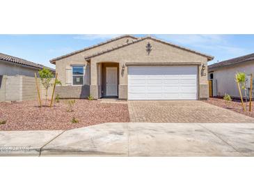 Charming single-story home with a two-car garage, low maintenance landscaping, and a well-maintained lawn at 24610 W Bowker St, Buckeye, AZ 85326