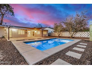 A refreshing backyard oasis featuring a sparkling pool and a peaceful outdoor area perfect for relaxation and entertainment at 317 E Belmont Ave, Phoenix, AZ 85020