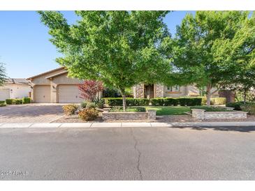 Charming single-story home with well-manicured lawn, mature trees, and a three car garage at 3648 E Fargo St, Mesa, AZ 85205