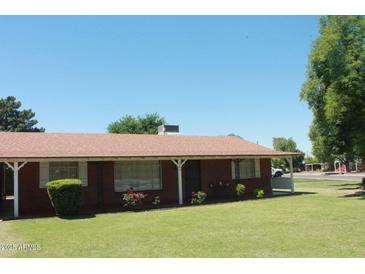 Charming single-story home with a well-maintained lawn and a classic brick facade at 3942 N 38Th St, Phoenix, AZ 85018