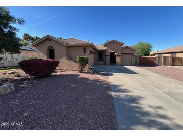Charming single-story home with a well-maintained yard and a spacious driveway at 4130 E Megan St, Gilbert, AZ 85295