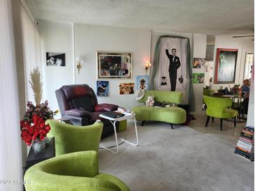 Bright living room with natural light, featuring unique decor, plush seating and a relaxing atmosphere at 815 N Hayden Rd # B4, Scottsdale, AZ 85257