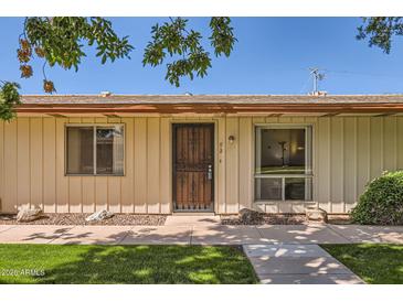 Charming single-story home with secure front door, beige siding, and easy-care landscaping at 8241 N Central Ave # 2, Phoenix, AZ 85020