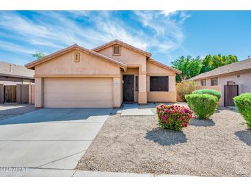 Charming single story home with landscaped yard and two car garage at 16515 N 71St Dr, Peoria, AZ 85382