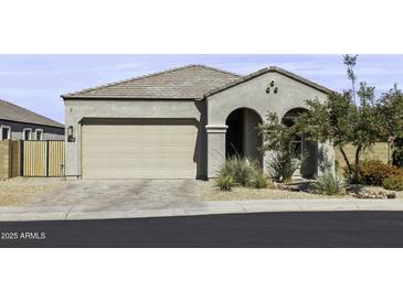 Charming single-story home with a two-car garage, arched entryway, and desert landscaping at 2354 E Lieber Pl, Phoenix, AZ 85024