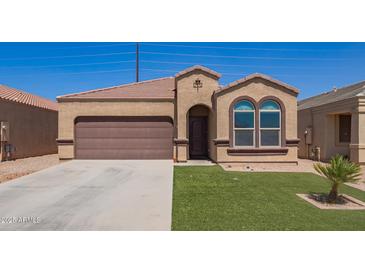 Well-maintained home with a neat lawn, a two-car garage and desert landscaping at 29109 N Fire Agate Rd, San Tan Valley, AZ 85143