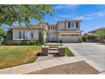 Attractive two-story home featuring a well-manicured lawn, desert landscaping, and a spacious two-car garage at 3169 E Eleana Ln, Gilbert, AZ 85298