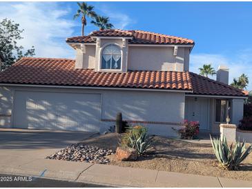Charming two-story home featuring desert landscaping, a red tile roof, and an attached two-car garage at 4636 E Carmen St, Phoenix, AZ 85044