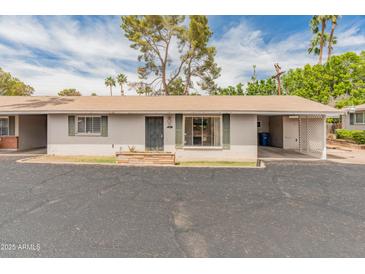 Charming single-story home featuring a covered carport and well-maintained front yard at 524 W Fairway Dr # 9, Mesa, AZ 85201