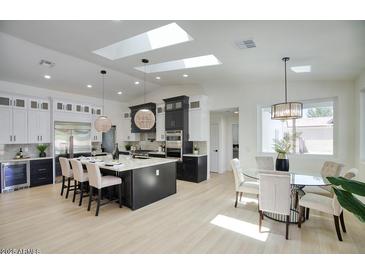 Bright, open kitchen with a large island, modern appliances, and skylights for natural lighting at 5430 E Shea Blvd, Scottsdale, AZ 85254