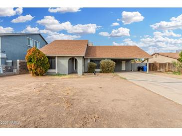 Charming single-story home with a carport, neutral paint, and low-maintenance landscaping at 9028 W Osborn Rd, Phoenix, AZ 85037