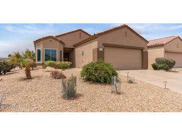 Charming single-story home featuring desert landscaping, a two-car garage, and a cozy, inviting facade at 16205 W Mountain Pass Dr, Surprise, AZ 85374