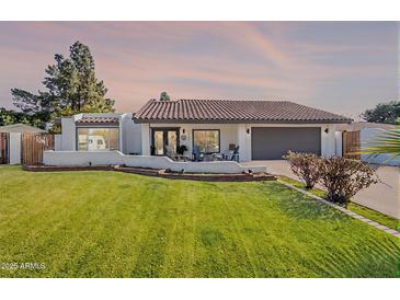 Charming single-story home with a well-manicured lawn and beautiful tiled roof at 1747 W Echo Ln, Phoenix, AZ 85021