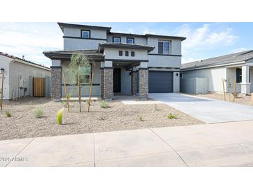 Stunning two-story home featuring a desert landscape and stone accents at 17977 W Camino De Oro Riv, Surprise, AZ 85387