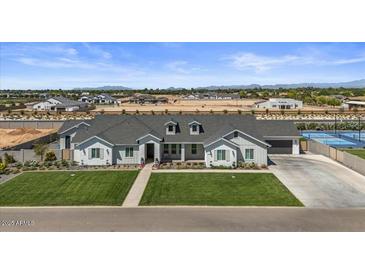 Beautiful single-Gathering home boasting manicured lawn, stone accents, and a three-car garage in a well-planned community at 18826 E Augusta Ave, Queen Creek, AZ 85142