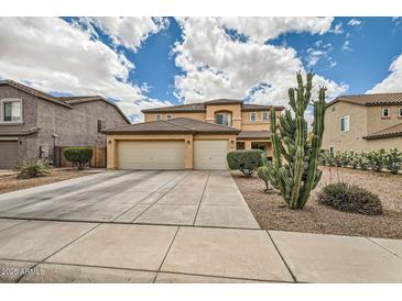Inviting two-story home featuring a three-car garage and desert landscaping at 3555 E Morenci Rd, San Tan Valley, AZ 85143