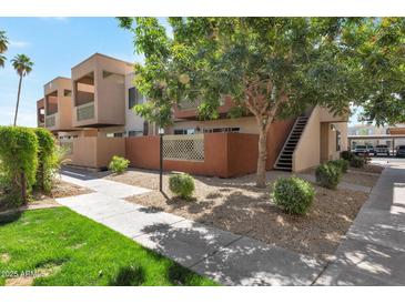 Charming townhome exterior with landscaped front yard and private balcony at 3600 N Hayden Rd # 3002, Scottsdale, AZ 85251