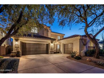 Desert home boasts a three car garage with tile roof and mature landscaping at 3641 E Los Gatos Dr, Phoenix, AZ 85050