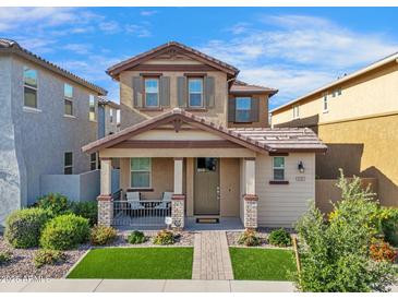 Charming two-story home featuring a cozy front porch and well-manicured landscaping with lush green grass at 4156 E Jesse St, Gilbert, AZ 85295