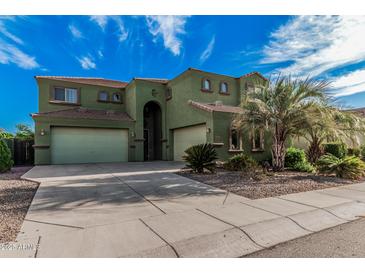 Inviting two-story home boasts three-car garage and meticulously landscaped front yard, perfect for curb appeal at 4413 E Odessa Dr, San Tan Valley, AZ 85140