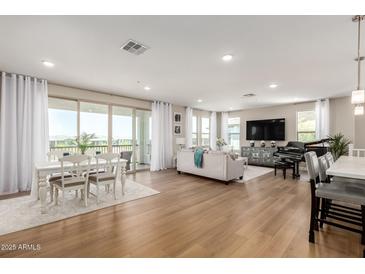 Spacious open-concept living area featuring hardwood floors, modern decor, and a dining area at 5100 E Rancho Paloma Dr # 2065, Cave Creek, AZ 85331