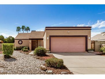 Charming single-story home featuring a two-car garage and a well-maintained front yard with desert landscaping at 6203 W Caribe Ln, Glendale, AZ 85306