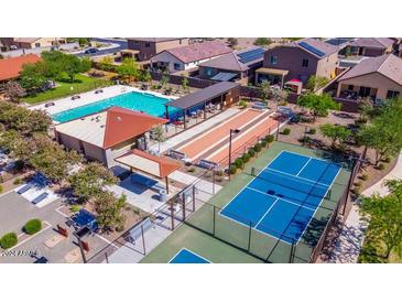 Aerial view showcasing the community's pool, tennis courts, bocce ball, and lush landscaping at 18219 W Daley Ln, Surprise, AZ 85387