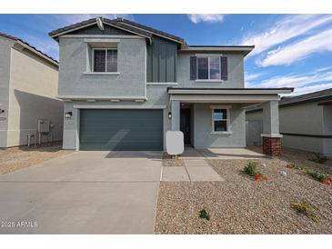 Charming two-story home featuring a spacious two-car garage and desert landscaping for low maintenance at 18236 W Daley Ln, Surprise, AZ 85387