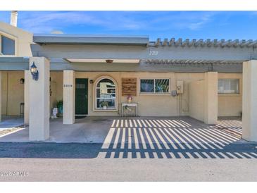 Charming facade of a home featuring a covered parking area with a decorative pergola for added curb appeal at 2219 E Catalina Dr, Phoenix, AZ 85016