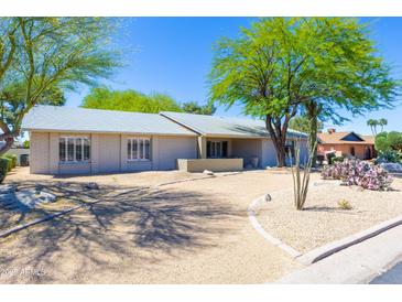 Charming single-story home with desert landscaping, mature trees, and a circular driveway at 2935 W Kristal Way, Phoenix, AZ 85027