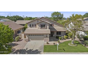 Two-story home featuring a neutral color scheme, well-maintained lawn, and an attached two-car garage at 3478 E Park Ave, Gilbert, AZ 85234