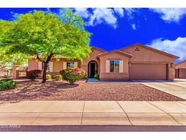 Charming single-story home with well-manicured landscaping and a welcoming entrance at 5635 W Pecan Rd, Laveen, AZ 85339
