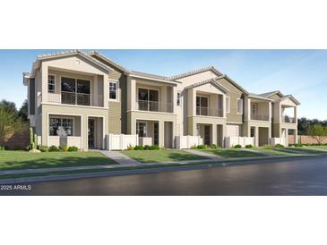 Charming townhome showcasing a two-story design, private balconies, and manicured landscaping, all set against a clear blue sky at 8149 E Petunia Ave # 1013, Mesa, AZ 85212