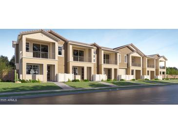 Charming townhomes with neutral exteriors, complemented by wrought iron balconies and well-manicured landscaping at 8149 E Petunia Ave # 1042, Mesa, AZ 85212