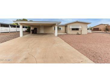 Charming single-story home with a covered carport and well-maintained landscaping at 8337 E Desert Trl, Mesa, AZ 85208