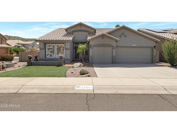 Charming single-Gathering home with a well-manicured lawn, desert landscaping, and a two-car garage at 14801 S 8Th St, Phoenix, AZ 85048