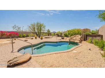 Backyard pool with waterfall feature and mature landscaping at 15107 E Desert Willow Dr, Fountain Hills, AZ 85268
