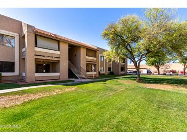 Charming condo building with well-maintained lawn and lush landscaping at 2146 W Isabella Ave # 131, Mesa, AZ 85202