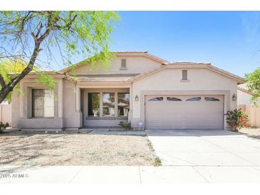 Charming single-story home with a two-car garage and desert landscaping under a clear, sunny sky at 2401 W Ellis St, Phoenix, AZ 85041