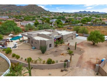 Modern desert home with a flat roof, sprawling landscape, private pool, and mountain views at 3019 W Trail Dr, Phoenix, AZ 85086
