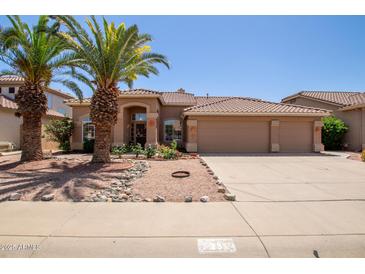 Beautiful single-story home with desert landscaping, tile roof, and a spacious three-car garage at 623 W Harvard Ave, Gilbert, AZ 85233