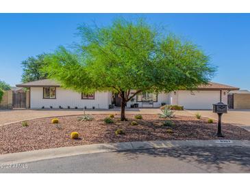 Charming home featuring low-maintenance desert landscaping, mature tree, and a mailbox at 8767 W Villa Hermosa --, Peoria, AZ 85383