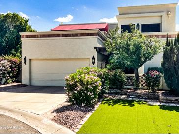 Charming home with manicured landscaping, artificial lawn, and a private two-car garage at 9241 S 50Th St, Phoenix, AZ 85044