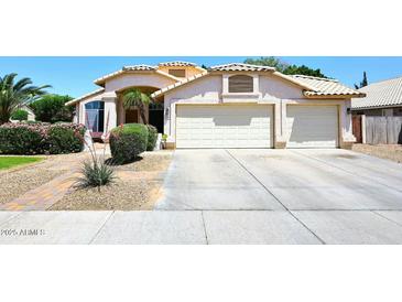 Charming single-Gathering home featuring a three car garage, desert landscaping, and beautiful tile roof at 1212 W Vera Ln, Tempe, AZ 85284