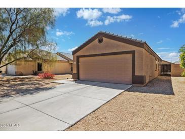Charming single-story home with a two-car garage and low-maintenance desert landscaping at 12621 W Willow Ave, El Mirage, AZ 85335