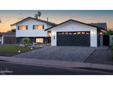 Beautifully renovated two-story home with a black garage door and dark trim accents at 1630 E Minton Dr, Tempe, AZ 85282