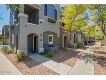 Attractive townhome featuring a well-maintained gray exterior, private balcony and low-maintenance desert landscaping at 280 S Evergreen Rd # 1320, Tempe, AZ 85288