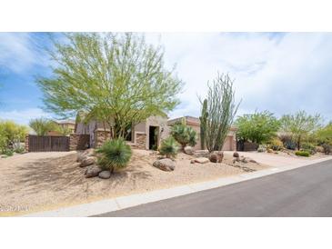 Charming single-story home featuring desert landscaping, mature trees, and an inviting entrance at 28019 N 115 Pl, Scottsdale, AZ 85262