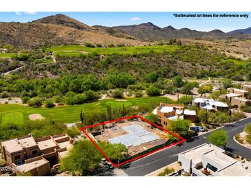 Aerial view of a lot outlined in red with a foundation next to a golf course at 38940 N 54Th St, Cave Creek, AZ 85331