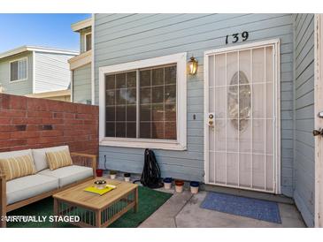 Inviting entrance with security door, and blue painted exterior with brick accent wall at 510 N Alma School Rd # 139, Mesa, AZ 85201
